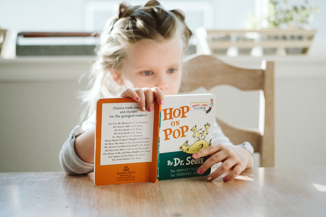 Photo by Josh Applegate girl sitting while reading book