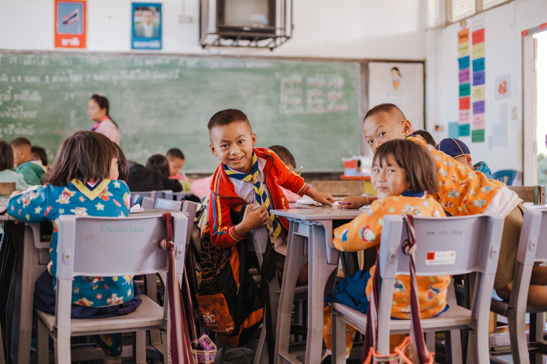 Photo by Mario Heller a group of children sitting at desks in a classroom